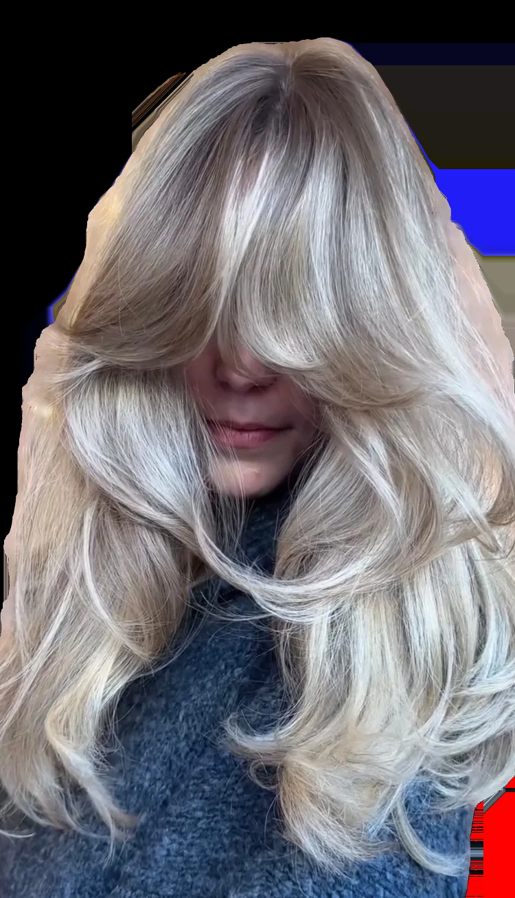Voluminous layered blonde blow-dry with soft waves
